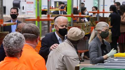 U.S. President Joe Biden talks to people as he visits the Houston Food Bank in Houston, Texas. Reuters