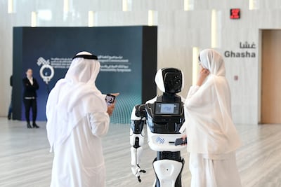 Guests entertained by a robot at the Mohamed bin Zayed University of Artificial Intelligence's inaugural commencement ceremony in Abu Dhabi. Khushnum Bhandari / The National