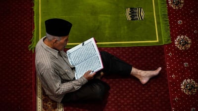 An Indonesian reads the Quran at the Al Makmur mosque in Banda Aceh. AFP