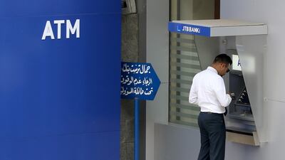 A man uses an ATM outside Jammal Trust Bank in Ashrafieh, Lebanon. Reuters