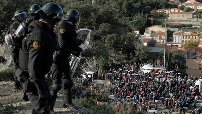 French police officers look at pro-Catalan independence demonstrators blocking a major highway border pass near La Jonquera between Spain and France AP