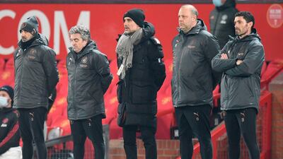 Manchester City manager Pep Guardiola and staff stand during a minute's silence in memory of Colin Bell. AFP
