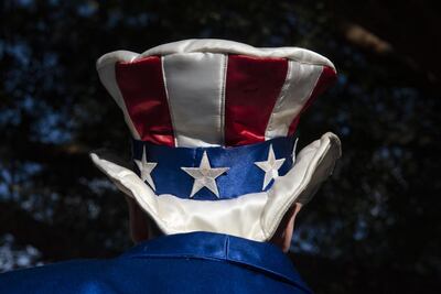 An attendee wears an American flag themed hat ahead of the Democratic presidential candidate debate in Houston. Bloomberg