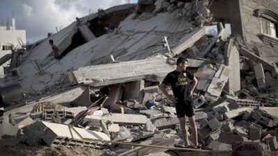 A Palestinian man stands on the rubble of a destroyed building following an Israeli military strike on Beit Lahya, in the northern Gaza Strip. AFP / Mahmud Hams