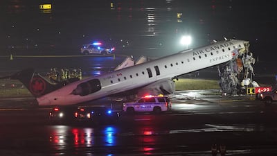 Emergency crews at at New York's La Guardia Airport after an Air Canada jet collided with a ground vehicle, killing two pilots and injuring passengers. Reuters