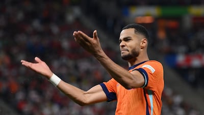 Dutch attacker Cody Gakpo celebrates after scoring their second, which was eventually given as an own-goal against Mert Muldur. Getty Images