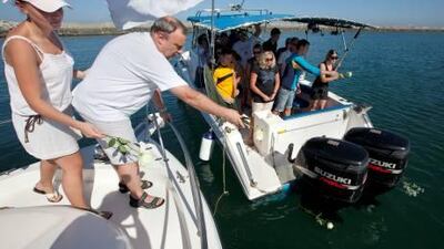 Georgy Evokin, the Russian team manager, throws flowers into the sea during a memorial ceremony in honour of the American swimmer Fran Crippen who died while taking part in the last leg of the 10km marathon swimming world cup in Fujairah on Saturday.