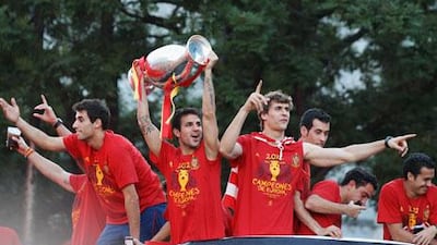 Cesc Fabregas leads the celebrations with the European Championship trophy after Spain's return to Madrid.