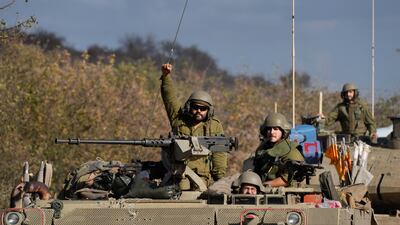 Israeli troops on armoured vehicles near the border with Lebanon. AP
