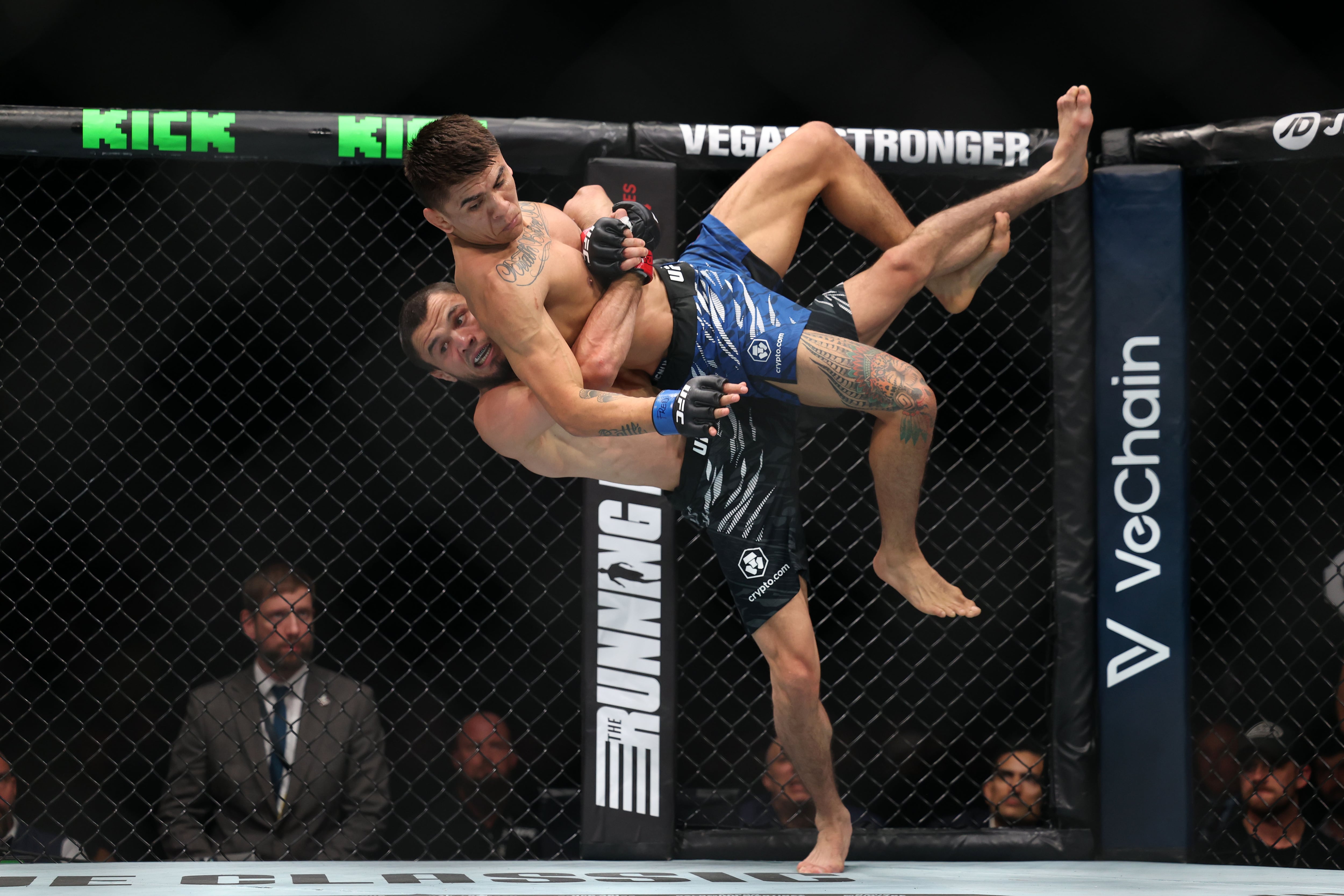 Umar Nurmagomedov (black shorts) beat Mario Bautista (blue shorts) by decision in a bantamweight bout at UFC 321.