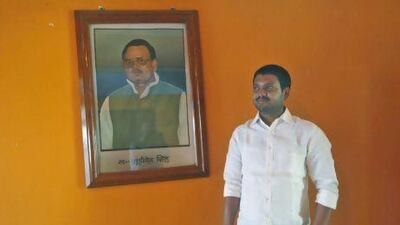 Sanjeev Singh, scion of the Singh Mansion, a dynasty of union leaders and coal traders, poses in front of a portrait of his father in October, 2012.