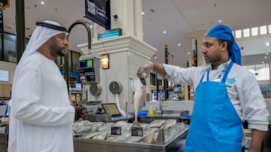 Shoppers browse the fish section at Al Jubail Market in Sharjah. Ahmed Ramzan / The National