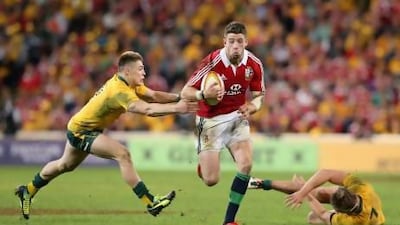 Alex Cuthbert of the Lions breaks clear of James O'Connor to score the Lions second.