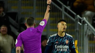 Arsenal's Gabriel Martinelli is shown a red card by referee Michael Oliver. Reuters