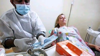 A dentist treats a tourist in Varkala, India. The regional healthcare sector presents opportunities for Indian companies targeting overseas contracts. Getty Images