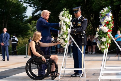 Donald Trump and former US Marine Corps Cpl Kelsee Lainhart place a wreath at Arlington National Cemetery in Vermont. AP