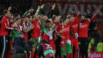 Wales players celebrate after their win on Tuesday night over Andorra to conclude Euro 2016 qualifying with a place in the tournament next year in France. Geoff Caddick / AFP