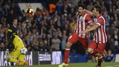 Atletico Madrid striker Diego Costa celebrates with Koke after converting his penalty shot on Wednesday against Chelsea. Toby Melville / Reuters / April 30, 2014