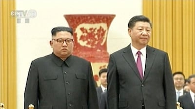 In this image taken from a video footage run by China's CCTV on June 19, 2018, via AP Video, Chinese President Xi Jinping, right, stands next to North Korean leader Kim Jong Un during a welcome ceremony at the Great Hall of the People in Beijing. CCTV via AP Video