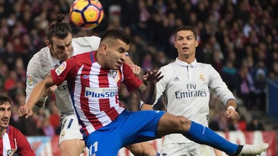 Real Madrid’s Welsh forward Gareth Bale, left, vies with Atletico Madrid’s Argentinian midfielder Angel Correa. Curto de la Torre / AFP