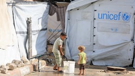 A Palestinian child collects water at a displacement camp in Gaza city, as Israeli proposals to relocate the entire population of the strip resurfaced. Reuters