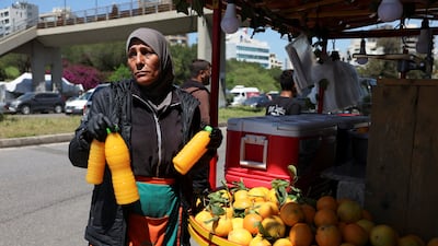 Amira Fadel works at her stall after her shop was bombed in the southern suburbs of Beirut. Reuters