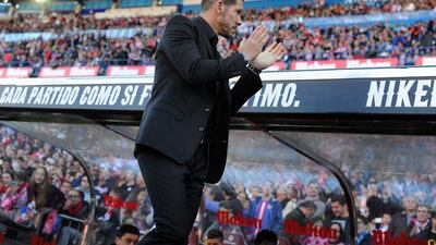 Manager Diego Simeone of Atletico Madrid applauds fans during his side's La Liga win over Granada on Sunday. Denis Doyle / Getty Images / April 17, 2016
