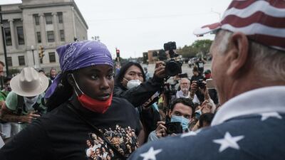 A demonstrator, left, and a supporter of US President Donald Trump, right, engage in verbal arguments in Kenosha, Wisconsin. Bloomberg