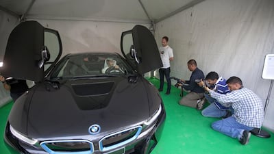 Dubai, United Arab Emirates, Apr 03, 2014 - His Highness Sheikh Mohammed bin Abdullah Al Thani check the BMW i8 at the Dubai Green Auto Show at The Pavilion Downtown Dubai-Sheikh Mohammed Bin Rashid Blvd. ( Jaime Puebla / The National Newspaper ) Martin Croucher - National