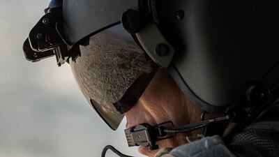 The Iraqi capital Baghdad reflected in the visor of a US Army helicopter crew member. All 'non-emergency' staff have been pulled from Iraq as uncertainty builds over the US's relationship with Iran. Reuters