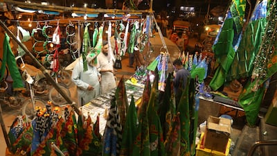 Shoppers buy decorative items on the roadside ahead of Eid-Milad-ul-Nabi, the birthday of Prophet Mohammed, in Karachi, Pakistan. EPA