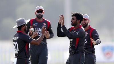 Amir Hayat, second right, of the UAE takes the wicket of Aaron Finch of Australia.