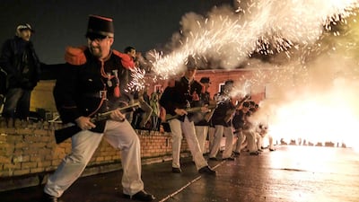 Participants dressed as Napoleonic soldiers put on a fire show. Olivier Hoslet / EPA