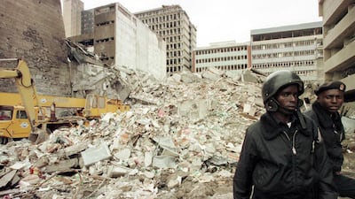 Kenyan security guards patrol the scene of an explosion near the US embassy in Nairobi on August 8, 1998. AFP