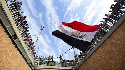 Iraqi protesters wave a national flag as they protest in Baghdad, Iraq, 25 October 2020. EPA