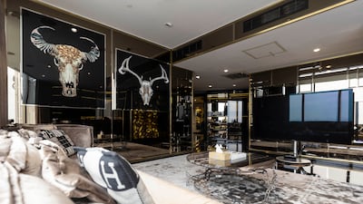 The TV room with a relaxation area next to the 'male' walk-in wardrobe