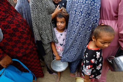 Palestinians wait for food from a WFP soup kitchen in Deir Al Balah, central Gaza. Reuters