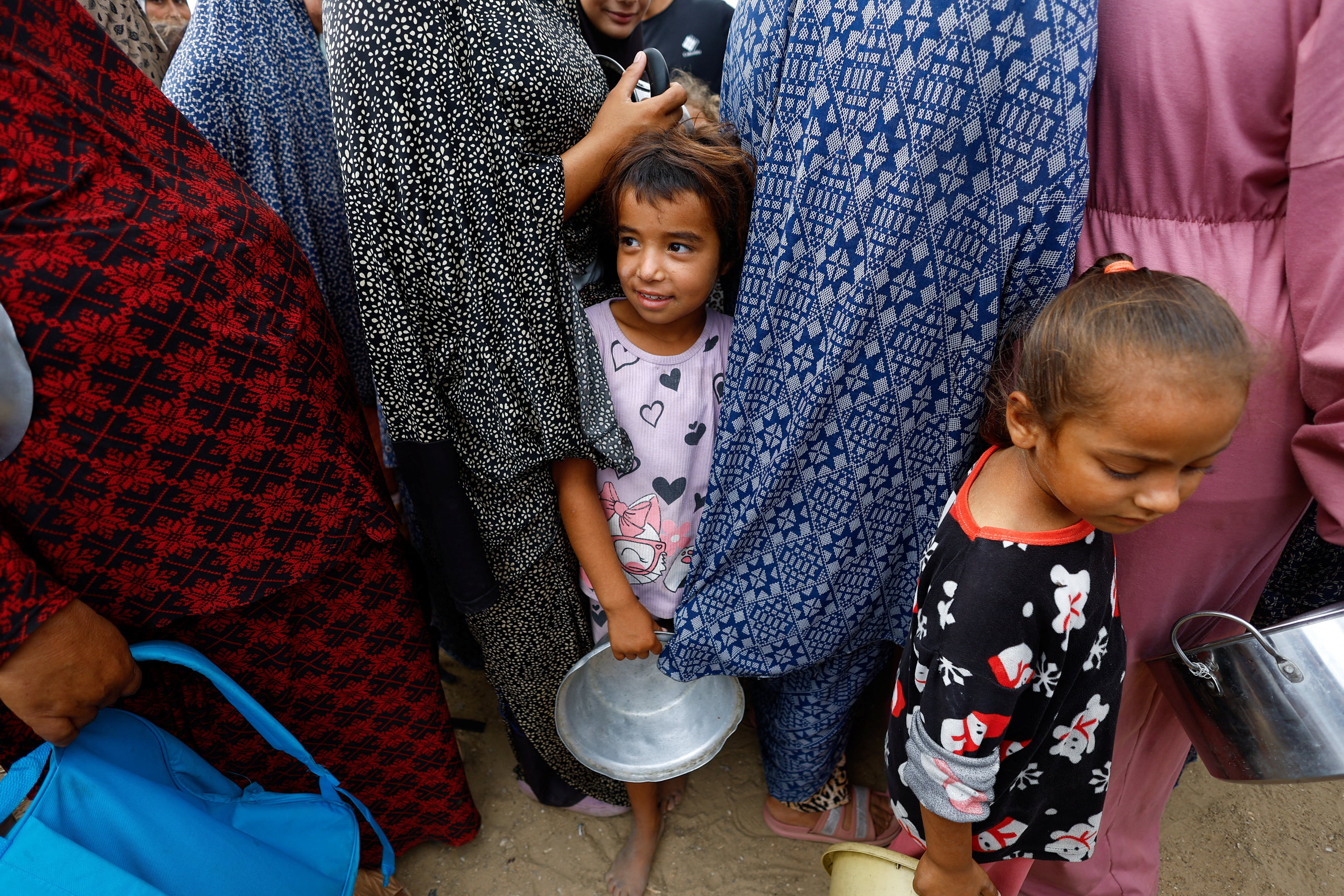 Palestinians wait for food from a WFP soup kitchen in Deir Al Balah, central Gaza. Reuters