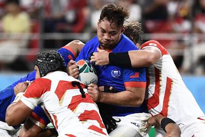 Samoa's Jack Lam is tackled during his team's 38-19 defeat to Rugby World Cup hosts Japan on Monday. AFP