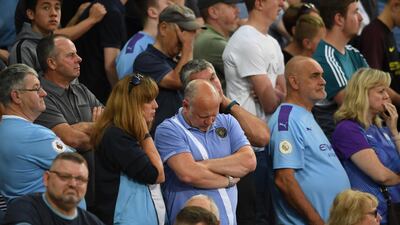 Manchester City fans look dejected during the match. EPA