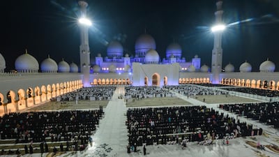 Muslims pray in the courtyard of Sheikh Zayed Grand Mosque on the occasion of Laylat Al Qadr, which marks the night in the fasting month of Ramadan during which the Quran was first revealed to Prophet Mohammed in the seventh century. Karim Sahib / AFP