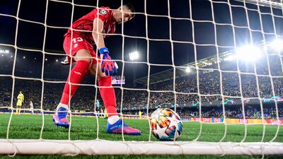 Villarreal goalkeeper Geronimo Rulli picks the ball out of the net after Dusan Vlahovic's goal. AFP