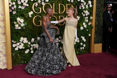 Ariana Grande, right, wore a vintage Givenchy dress. AP