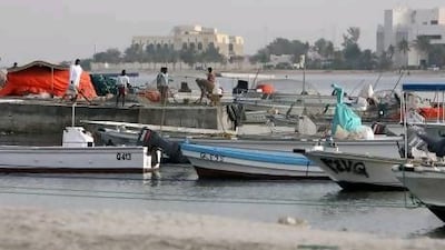 Fishing boats moored at the harbour overlooking the Old Town area of Umm Al Quwain.