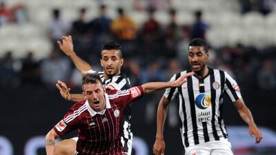 Al Wahda’s Damian Diaz takes a tumble after a challenge by Al Jazira’s Ali Mabkhout in Abu Dhabi on Sunday night. Courtesy Al Ittihad