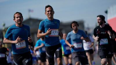 People run as they take part in the "Journee Olympique" ("Olympic day") in Paris, on June 23, 2019. A total of thirty Olympic and paralympic sports will be presented on Place de la Concorde in Paris. AFP