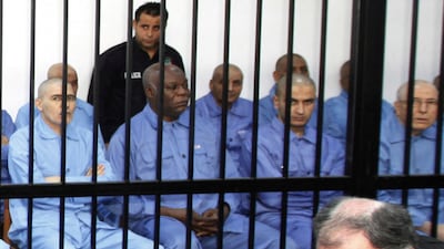 Abu Agila Mohammad Masud (2nd L) sits behind bars during a hearing at a courtroom in Tripoli November 16, 2014. Reuters