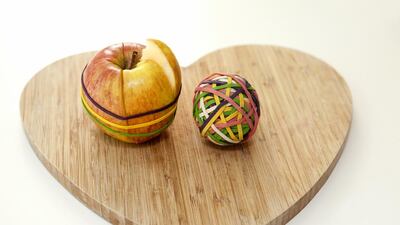 One life hack includes slicing an apple then putting it back together with a rubber band to stop it from going brown in your child’s lunch box. Courtesy Getty Images