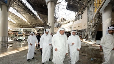 Officials inspect damage at Kuwait International Airport following an Iranian drone and missile attack on Wednesday. Reuters