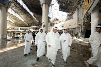 Kuwaiti officials attend the scene of an Iranian attack on Kuwait's international airport on Wednesday. Reuters